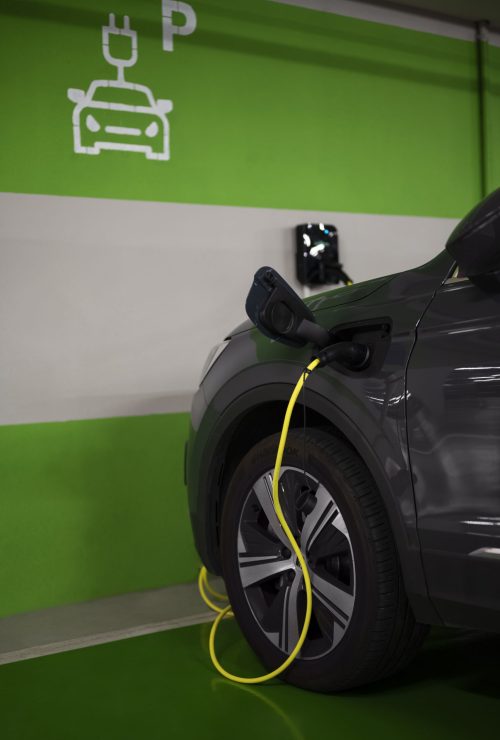 side-view-electric-car-charging-parking-lot